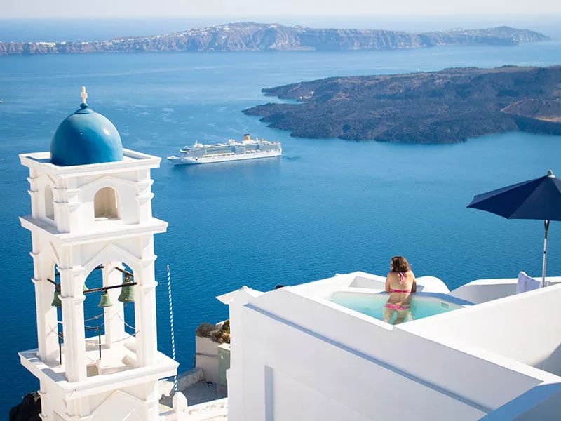 accomodation-in-greece-white-blue-house-looking-into-the-aegean-as-a-ferry-is-passing-by