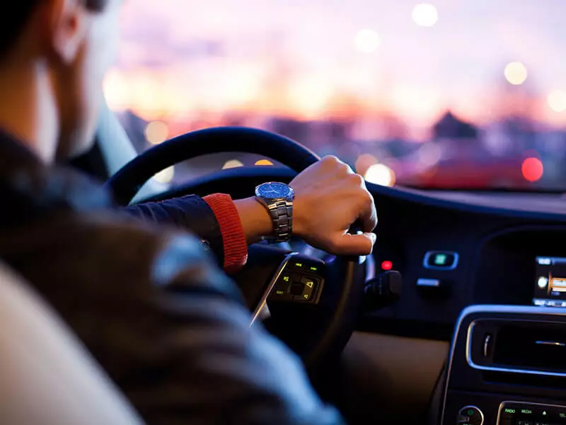 man-is-driving-car-with-view-of-city